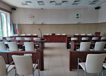 Pomieszczenie, w którym ustawione są rzedy jasnych krzeseł